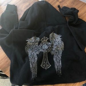 Zip up jacket, black with angel wings on back.